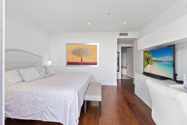 bedroom with baseboards, dark wood finished floors, visible vents, and recessed lighting