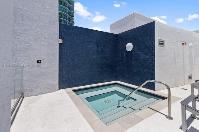 view of swimming pool with a community hot tub