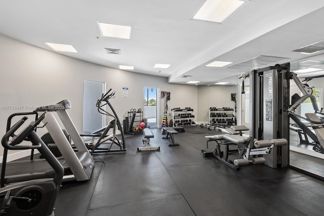 gym with baseboards and visible vents