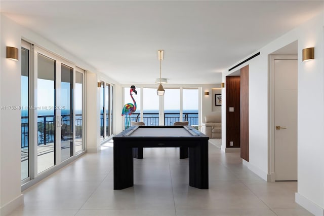 playroom with a wall of windows, pool table, plenty of natural light, and baseboards