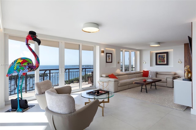 living room with a water view, a healthy amount of sunlight, and tile patterned floors
