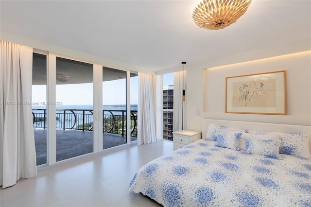 bedroom with access to exterior and a wall of windows
