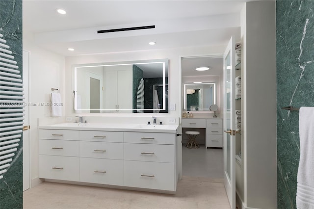 full bathroom featuring double vanity, a sink, and recessed lighting