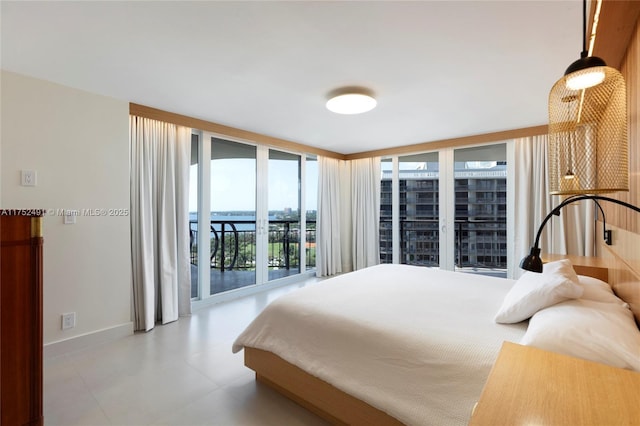 bedroom with access to exterior, expansive windows, and baseboards