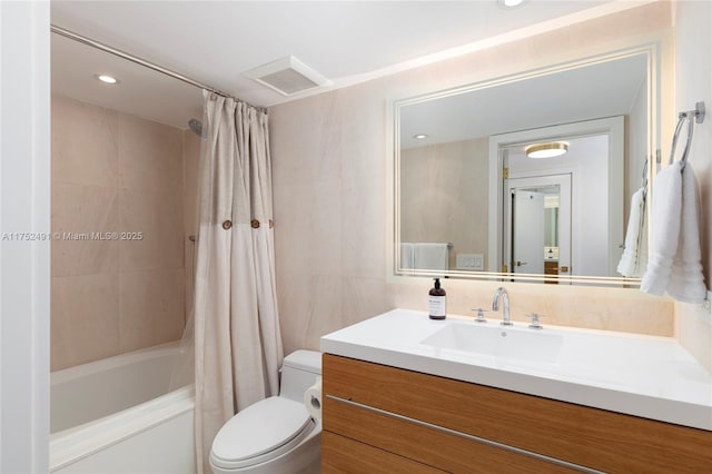 full bath featuring shower / tub combo, visible vents, toilet, vanity, and tile walls