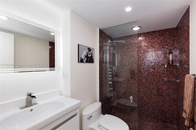 bathroom with toilet, recessed lighting, walk in shower, and vanity
