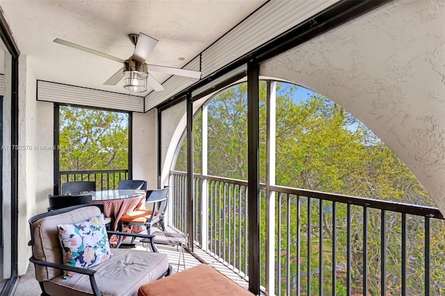 sunroom with a ceiling fan