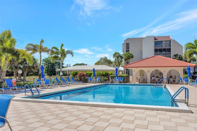 pool featuring a patio and fence