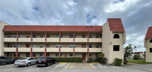 view of building exterior with uncovered parking