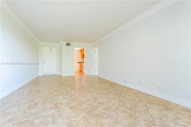 spare room with light tile patterned floors, ornamental molding, visible vents, and baseboards