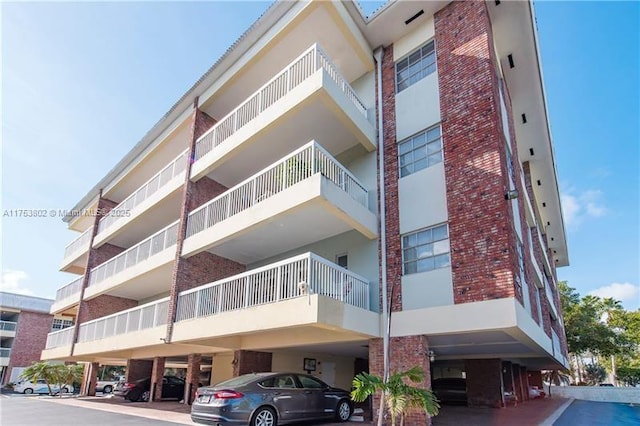 view of building exterior featuring covered parking