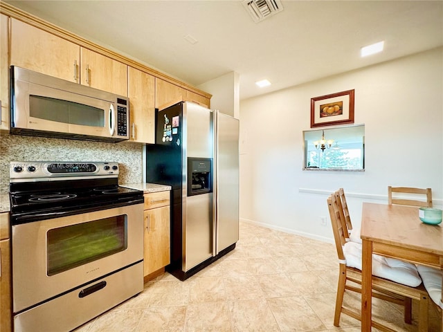 kitchen with baseboards, visible vents, decorative backsplash, stainless steel appliances, and light brown cabinetry