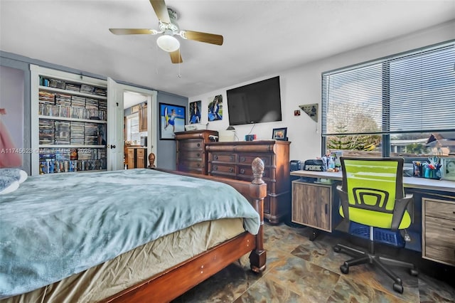 bedroom featuring ceiling fan and stone finish floor