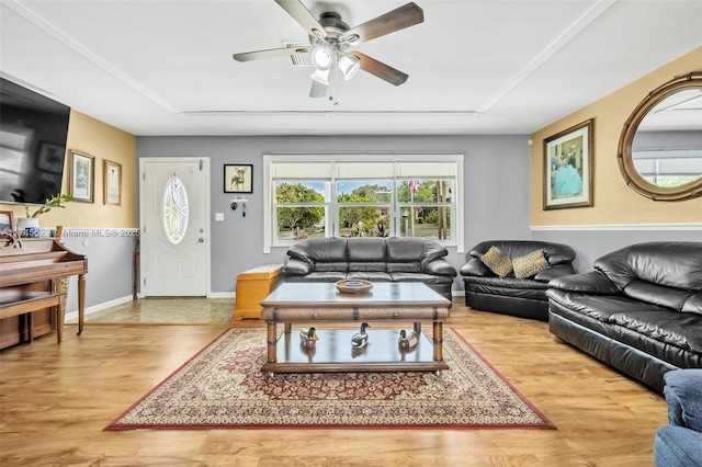 living room with ceiling fan, baseboards, and wood finished floors