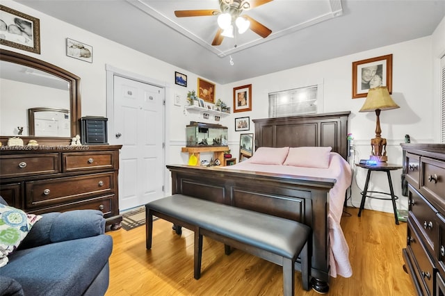 bedroom with light wood-style flooring and a ceiling fan