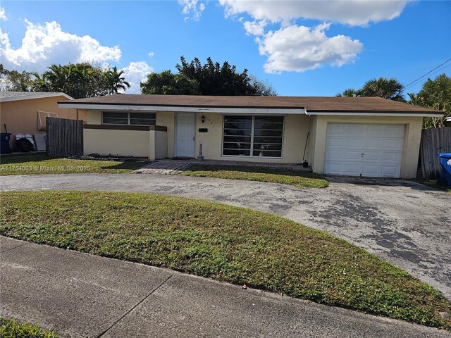 single story home featuring aphalt driveway, stucco siding, an attached garage, a front yard, and fence