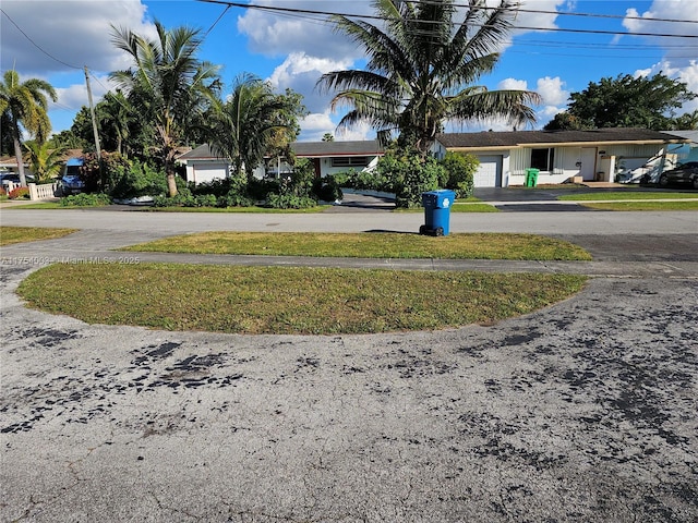 view of yard with driveway and an attached garage