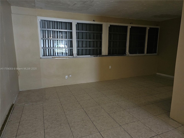 unfurnished room with tile patterned flooring