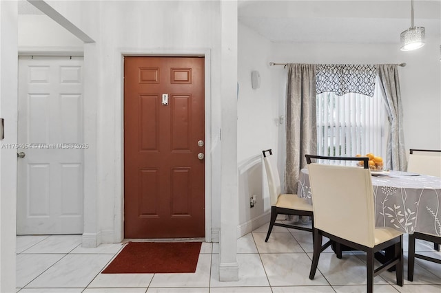 foyer entrance featuring light tile patterned floors and baseboards