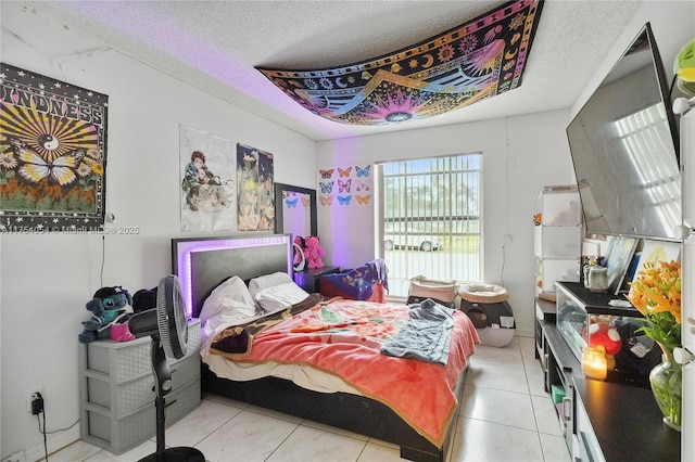 bedroom featuring light tile patterned flooring and a textured ceiling