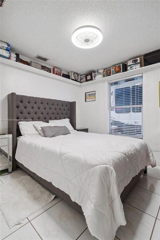 bedroom featuring visible vents and a textured ceiling