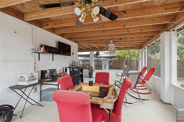 view of patio / terrace with ceiling fan, fence, and outdoor dining space