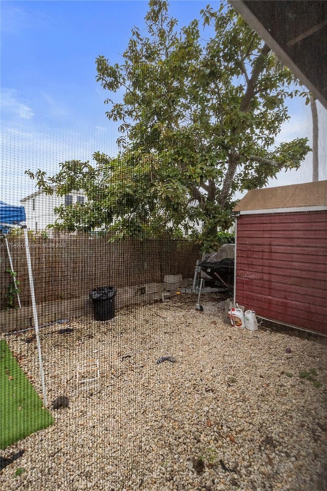 view of yard featuring a storage unit and an outdoor structure