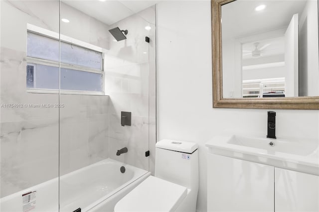 bathroom with bathing tub / shower combination, a sink, and toilet