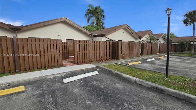 uncovered parking lot featuring fence private yard