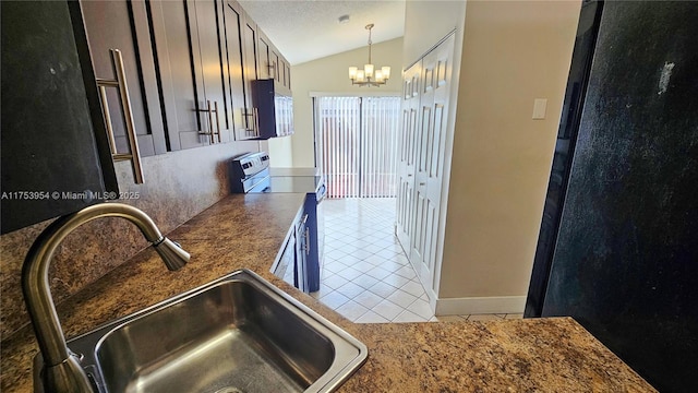 kitchen featuring range with electric stovetop, lofted ceiling, a sink, a notable chandelier, and light tile patterned flooring