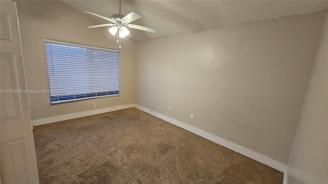 carpeted spare room featuring ceiling fan, a textured ceiling, and baseboards