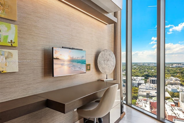 unfurnished office featuring a city view and tile patterned floors