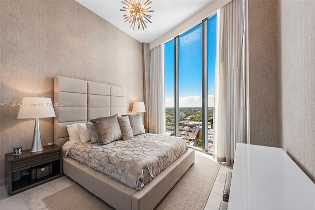 bedroom with wallpapered walls, light tile patterned flooring, and access to exterior