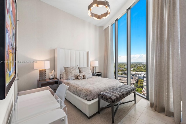 bedroom with floor to ceiling windows and light tile patterned flooring