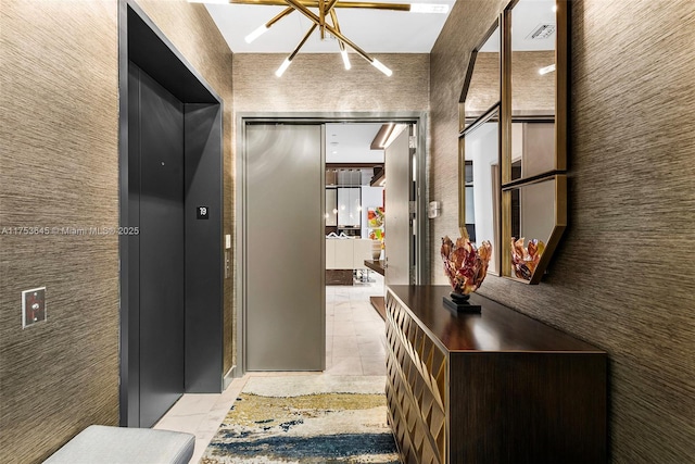 hallway featuring elevator and visible vents