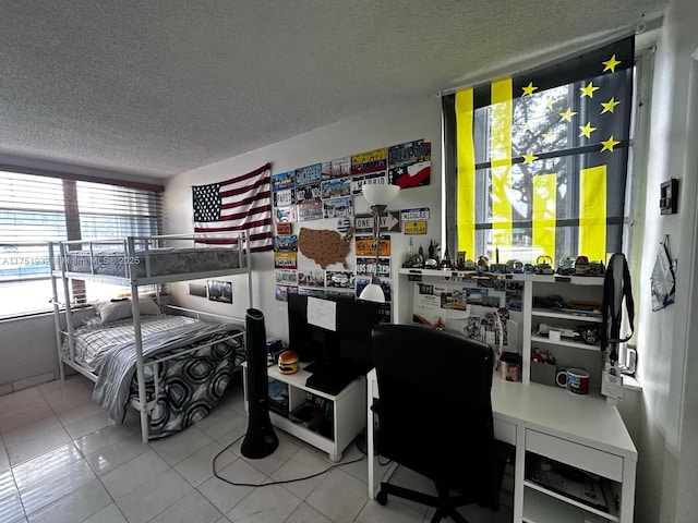 bedroom with tile patterned flooring and a textured ceiling