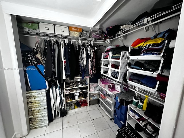 walk in closet with tile patterned floors