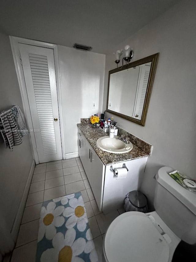 bathroom featuring visible vents, vanity, tile patterned flooring, and toilet