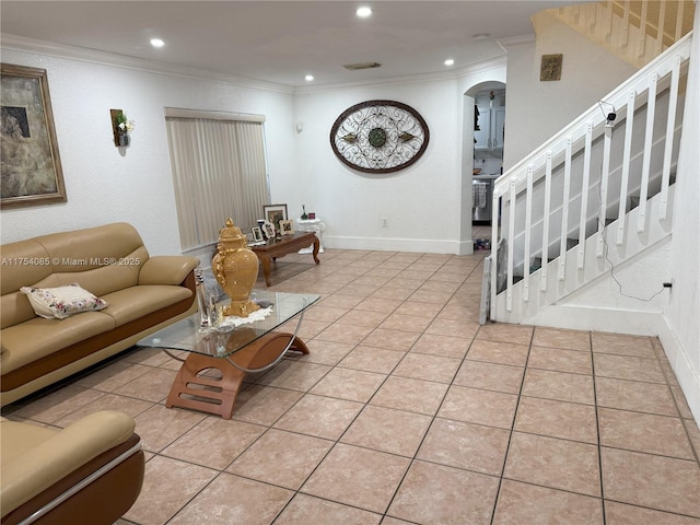 living room with light tile patterned floors, arched walkways, and crown molding