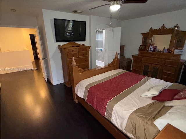 bedroom featuring ceiling fan, wood finished floors, and visible vents