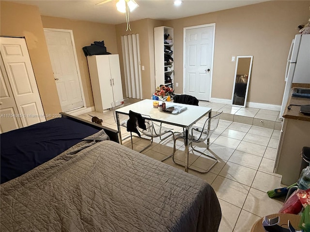 bedroom with light tile patterned floors and baseboards