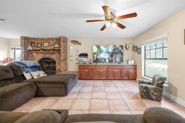 living room with light tile patterned floors, plenty of natural light, and a brick fireplace