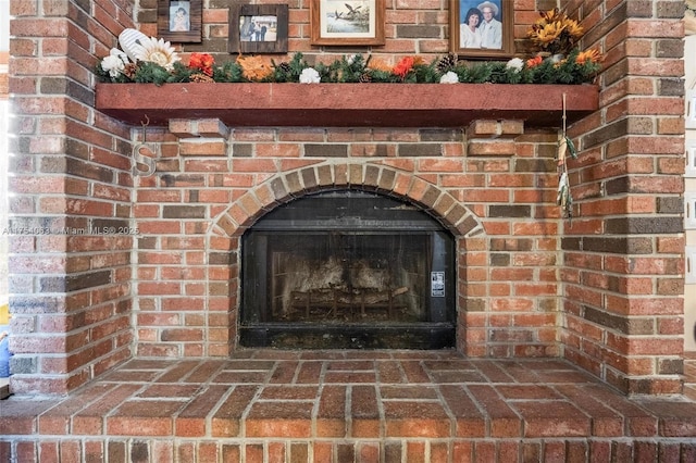 interior details with a brick fireplace