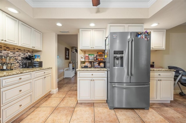 kitchen featuring light tile patterned flooring, tasteful backsplash, ornamental molding, and stainless steel fridge with ice dispenser