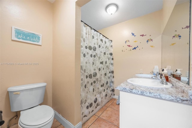 bathroom with toilet, vanity, a shower with curtain, baseboards, and tile patterned floors