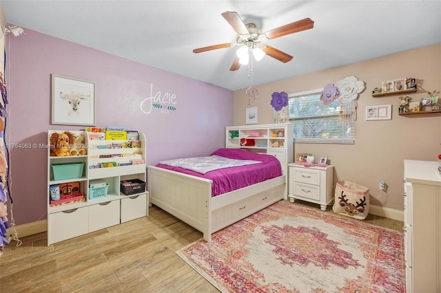 bedroom with ceiling fan, baseboards, and wood finished floors