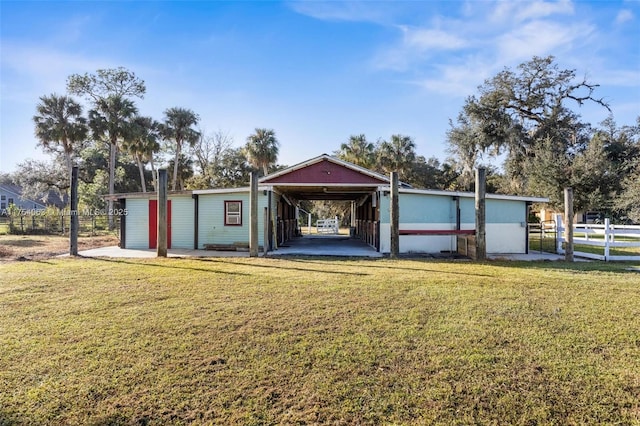 garage with an attached carport and fence