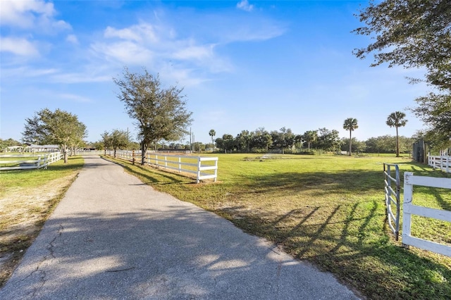 view of road featuring aphalt driveway and a rural view