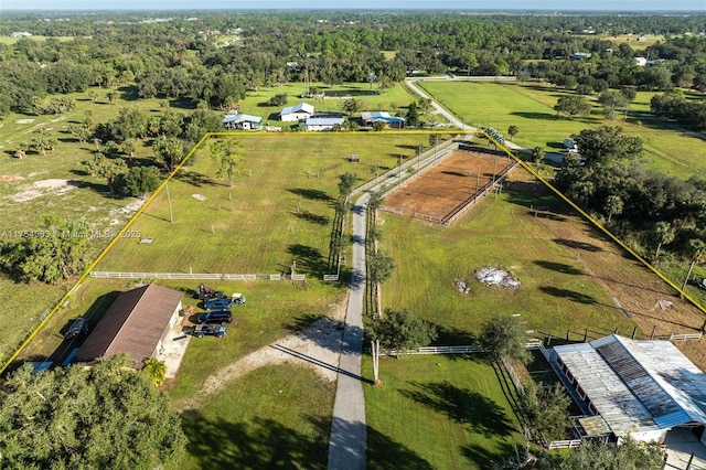 birds eye view of property with a forest view and a rural view