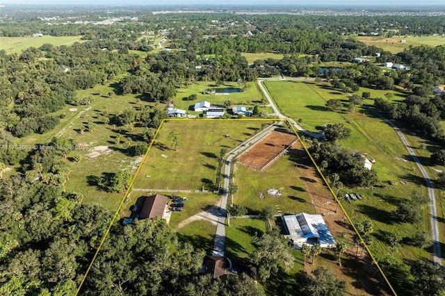 birds eye view of property with a wooded view